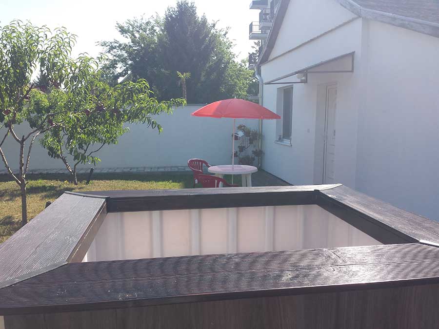 Couples enjoying a private wood-fired hot tub in Subotica garden retreat