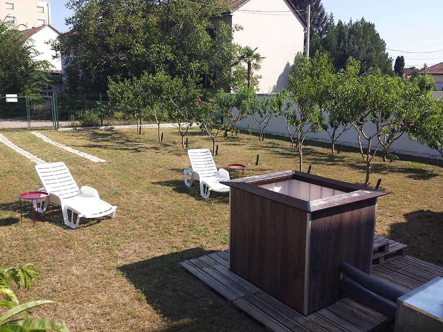 Private wood-fired hot tub relaxation area in Subotica garden retreat