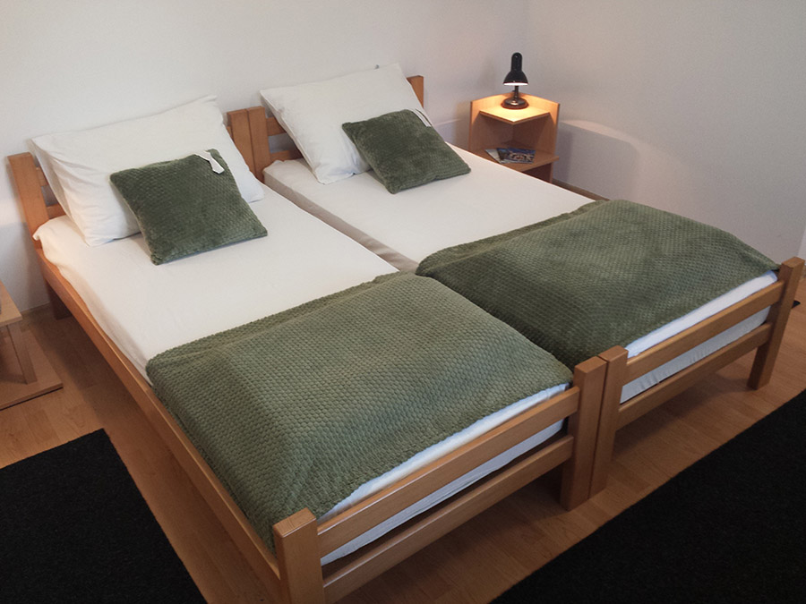 Cozy bedroom with double bed in a private studio apartment in Subotica