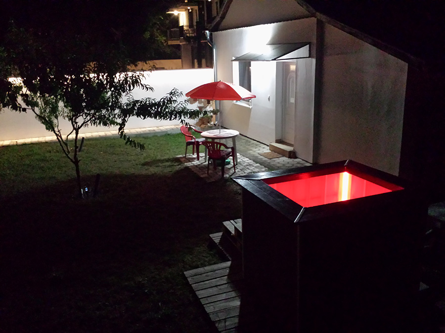 Outdoor wood-fired hot tub at night in Subotica, Serbia