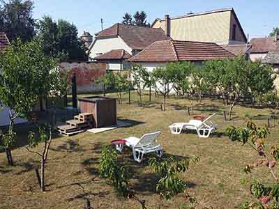 Private garden retreat with outdoor wood-fired hot tub in Subotica